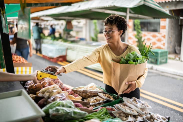 Lady buying produce from a local market