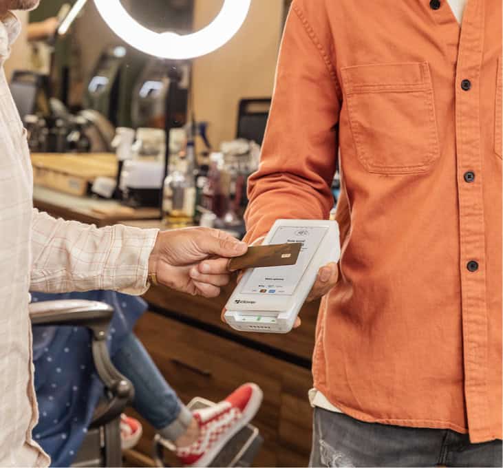 A hand tapping credit card on a Rescue smart terminal